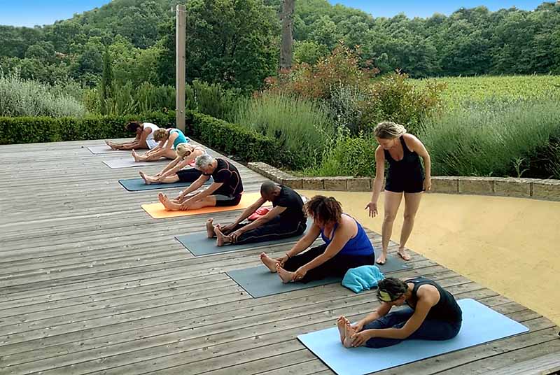Vrouw in kleermakerszit die zichzelf reiki geeft tijdens yoga